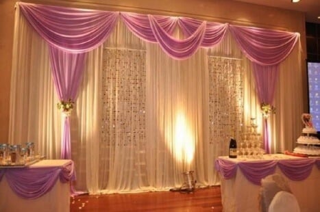 A great example of a white pipe and drape rental with pink/purple highlights. 